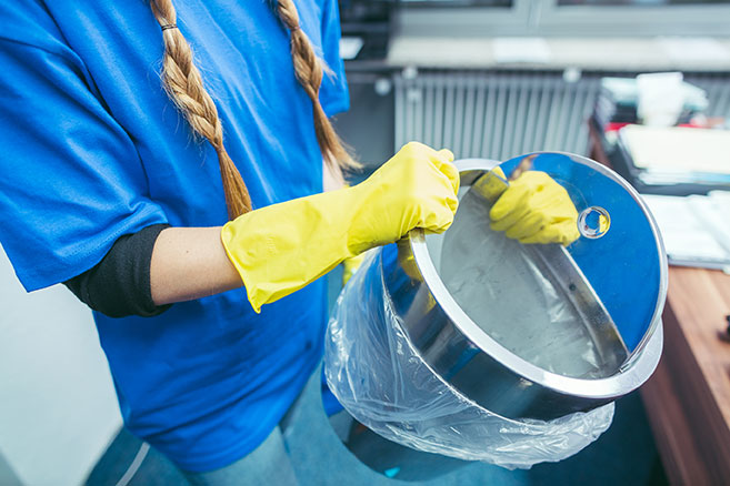 Janitor empties the trash.