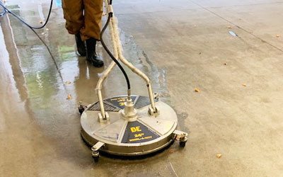 pressure washing machine cleans exterior concrete.