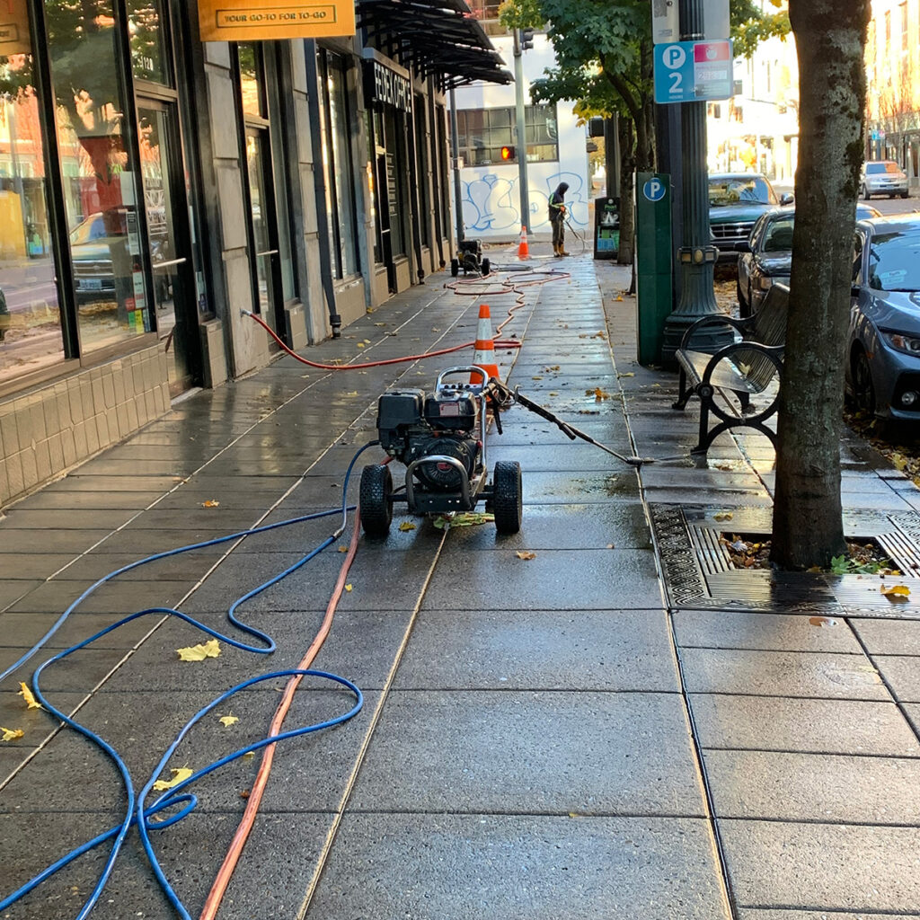 Pressure washing storefronts and sidewalks.