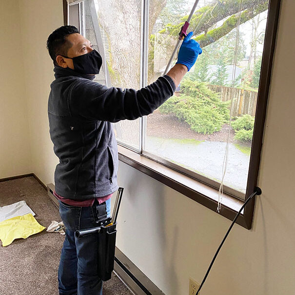 Man squeegee cleans a windows.